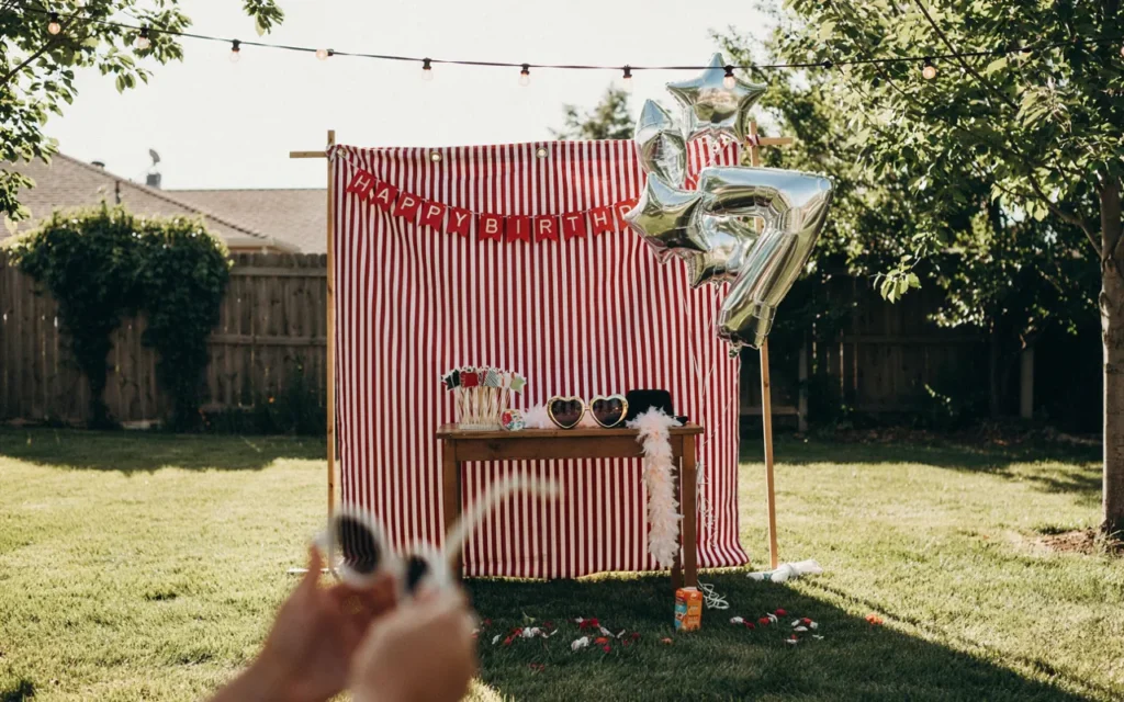 Backyard Photo Booth with Stars and Stripes Backdrop